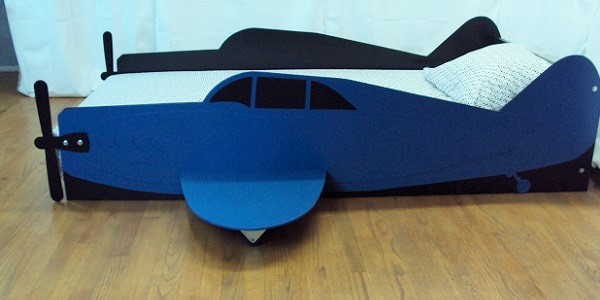 Blue propeller plane bed side view